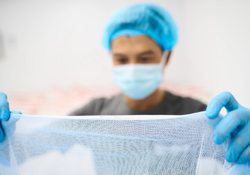 Man inspects fabric for quality control