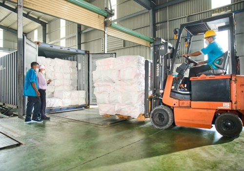 Fork lift brings fabric into a storage container